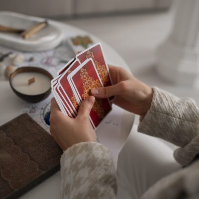high-angle-woman-reading-tarot-home (1)